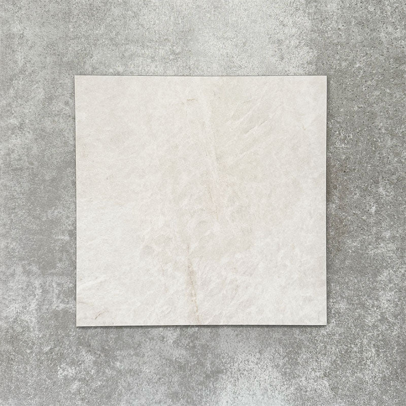 Close-up of Divine Taj Mahal matt marble-effect tile in a 30cm x 30cm format, featuring soft ivory and warm cream tones with subtle natural stone-inspired movement. The understated marble effect creates a timeless and elegant finish, making it ideal for chequerboard floor designs, bathrooms, hallways and sophisticated interior spaces.