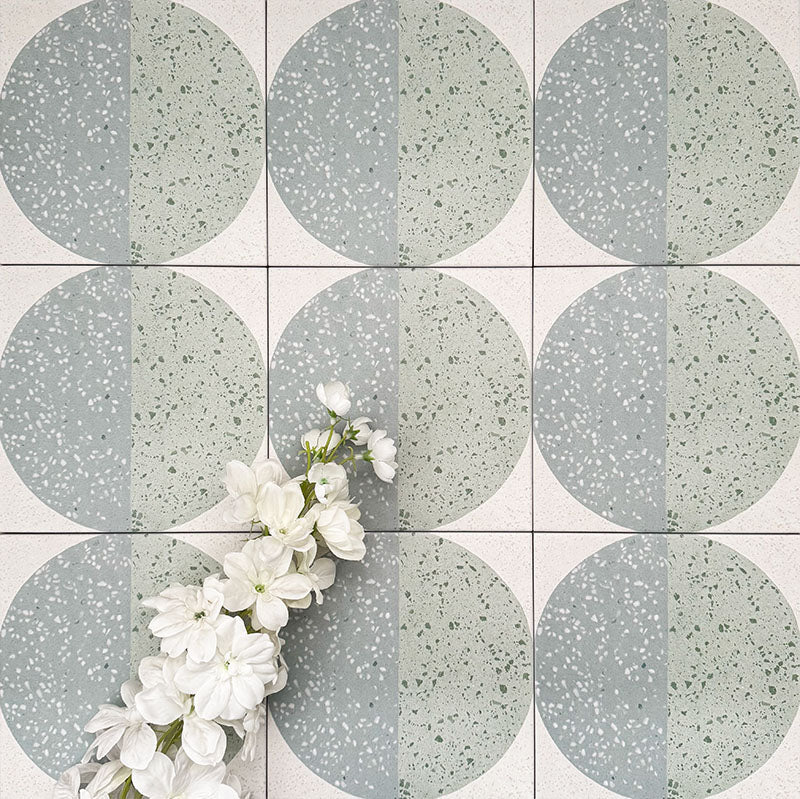 Eclipse Salvia 20x20cm terrazzo-style decor tiles featuring a soft sage and pale blue circular pattern, designed to bring a playful yet calming geometric look to contemporary interiors.