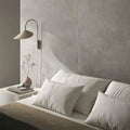 Bedroom interior featuring Etna Grey Matt 60 × 60cm porcelain wall tiles, styled with soft neutral bedding, a minimalist bedside table, and warm lighting for a calm, contemporary, restful space.