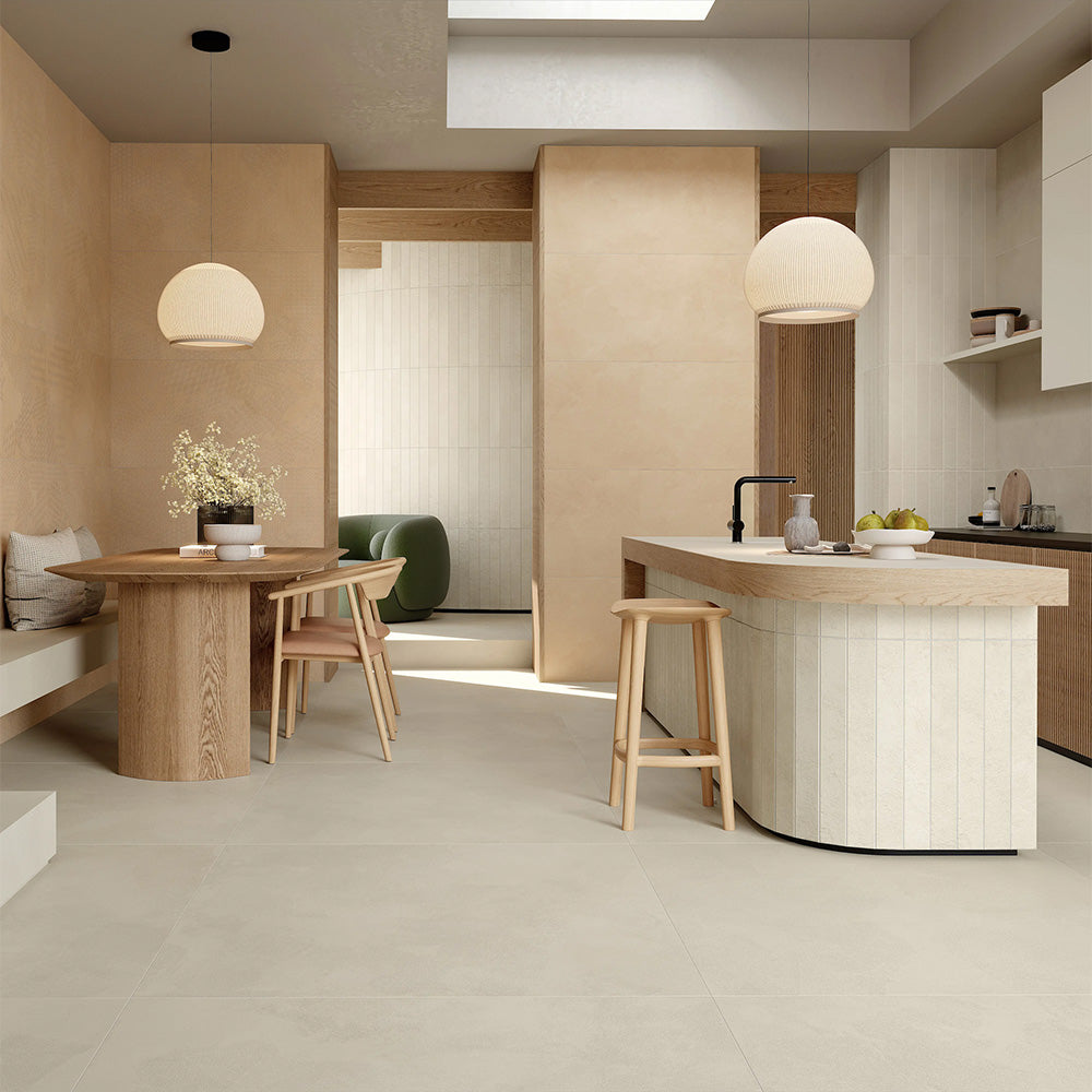 Kitchen interior featuring Etna Marfil Matt 60 × 120cm porcelain floor tiles, styled with warm wood cabinetry, a central island, soft neutral tones, and natural light for a calm, contemporary, design-led space.