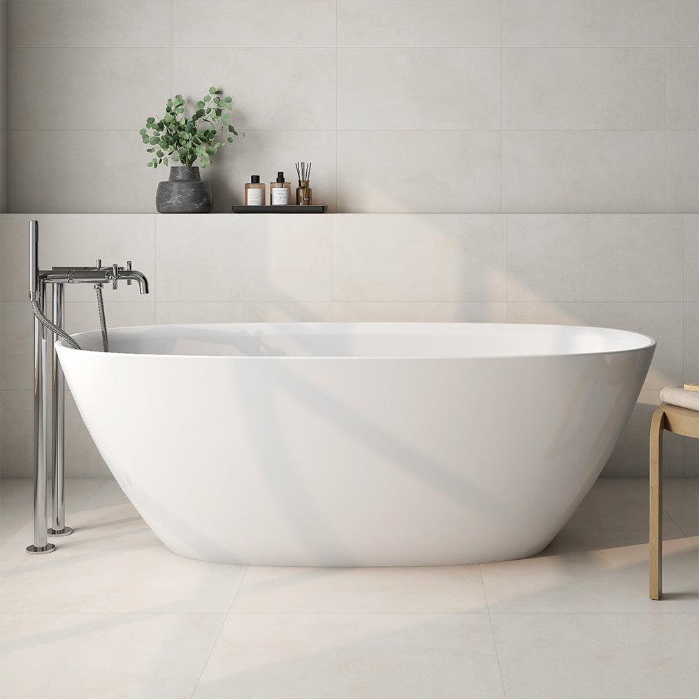 Bathroom interior featuring Etna Marfil Matt 60 × 60cm porcelain wall and floor tiles, styled with a freestanding bath, chrome fittings, and soft neutral tones for a calm, modern, spa-like setting.