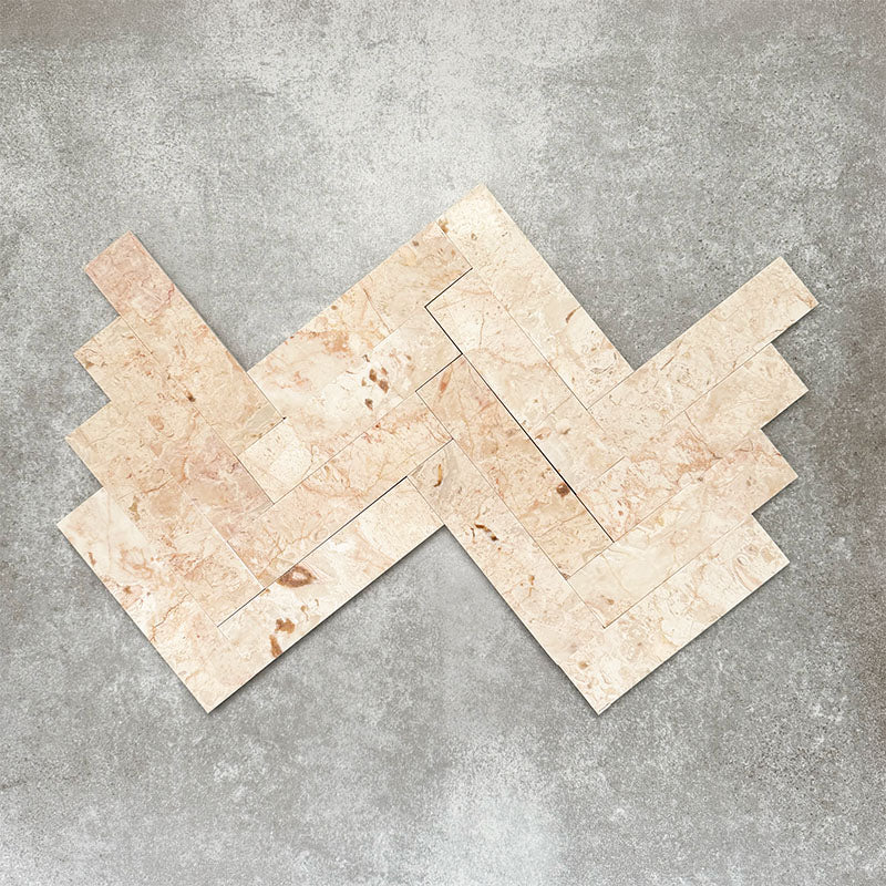 Herringbone tile layout showcasing Fayrouz Sylvester Pink 5cm x 20cm honed natural marble tiles, featuring soft pink, cream and beige tones with natural veining, perfect for elegant walls and decorative floors.