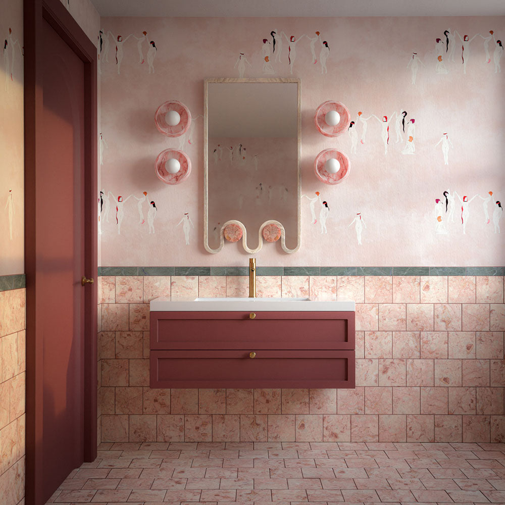 Bathroom featuring Fayrouz Verde Honed Finish natural marble 5cm x 20cm brick wall tiles paired with a blush pink vanity, brass tap, decorative wallpaper and soft contemporary lighting.
