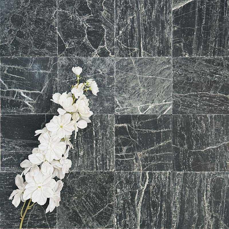 Fayrouz Verde tumbled natural marble tiles in a 15.2cm x 15.2cm format, showcasing rich deep green tones, striking white veining and authentic stone variation with a beautifully aged tumbled finish.
