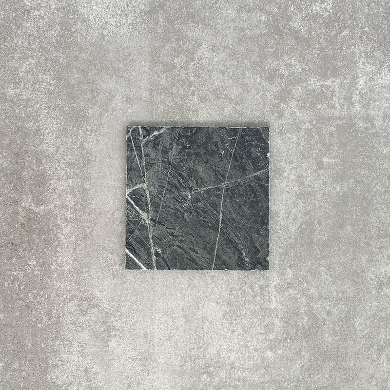 Close-up of Fayrouz Verde tumbled natural marble tiles in a 15.2cm x 15.2cm format, showcasing rich deep green tones, striking white veining and authentic stone variation with a beautifully aged tumbled finish.