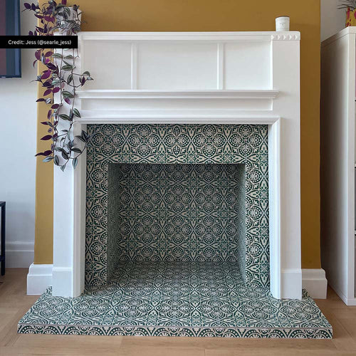 Fireplace hearth and surround featuring Cuba Fleur de Lis Moroccan-style porcelain tiles in a 20×20cm square format, displaying an intricate green and white decorative pattern, framed by a white mantelpiece to create a striking focal point with timeless, encaustic-style character.