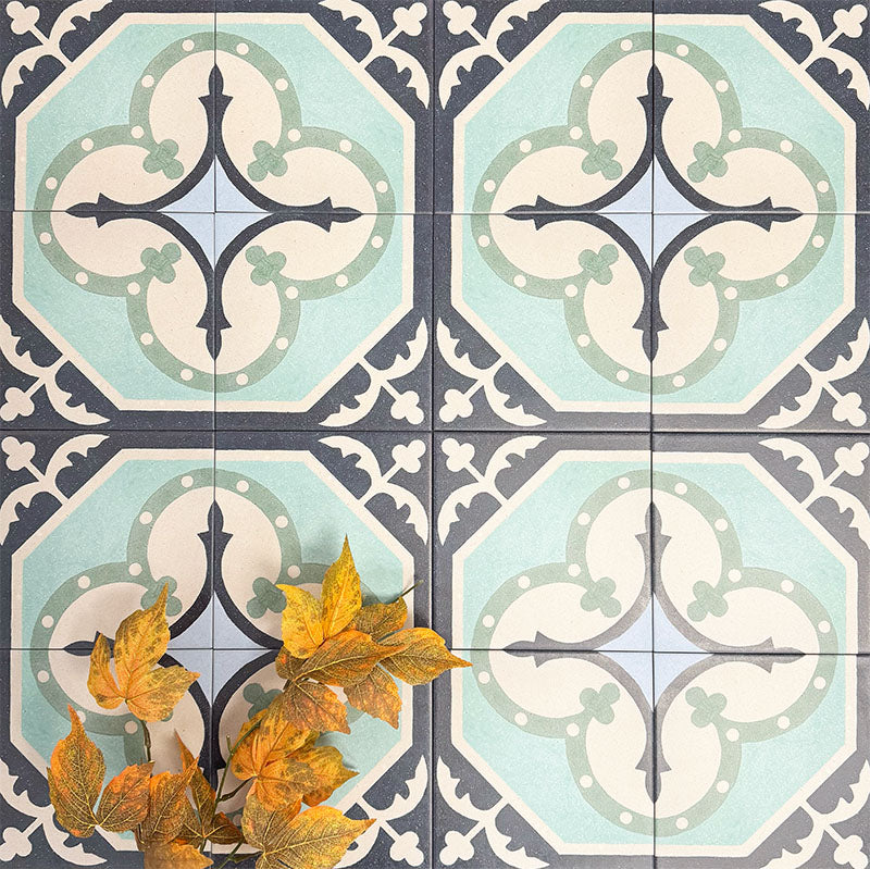 Group of London Streets Goodwin Court 20x20cm Victorian Moroccan style porcelain tiles arranged to showcase the repeating soft blue, cream and charcoal geometric pattern, styled with autumn leaves in a decorative flat-lay setting.