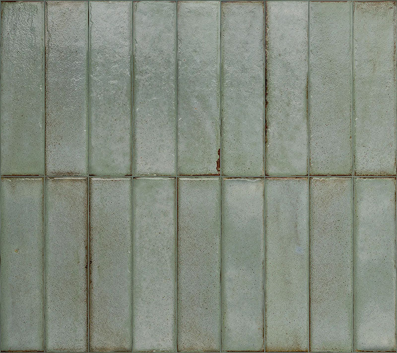 Puzzle Sage Green Brick Rectified 5x20cm porcelain tiles displayed in a full layout, showcasing soft sage green tones with gentle speckling and natural shade variation across each brick. The rectified edges create clean, uniform lines, while the subtle surface texture adds depth and a refined handmade aesthetic to both wall and floor installations.