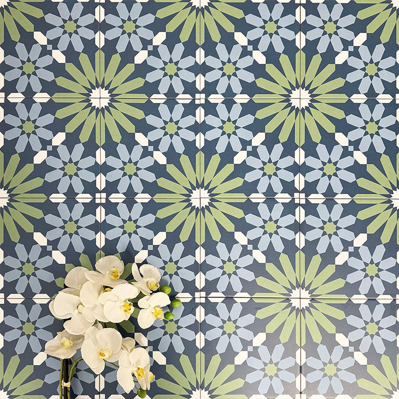 Fez Springs 20x20cm Moroccan-style porcelain wall tiles arranged in a repeating geometric pattern, featuring layered blue and soft green star motifs, styled with white floral accents for a fresh, decorative finish.