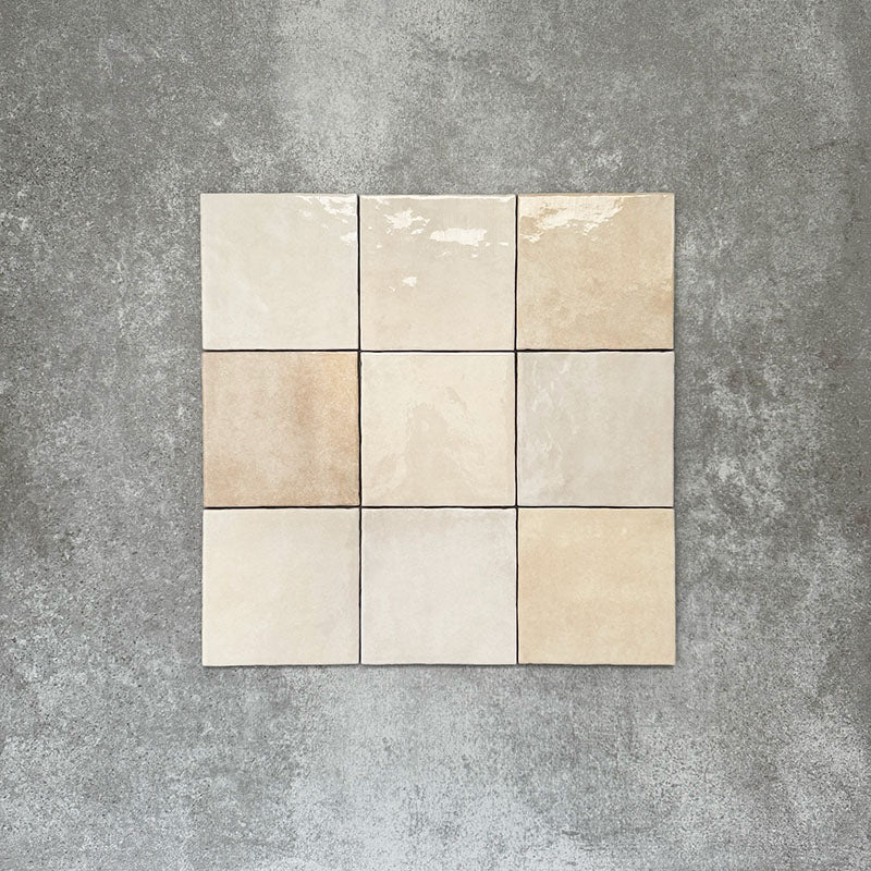 Zellige Bone square tiles laid in a simple grid, featuring a glossy white finish with subtle tonal variation and softly uneven edges.