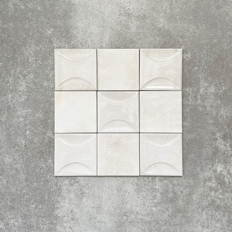 Saigon White Decor Square Wall tiles shown in a grouped layout, featuring Moroccan-style 10 × 10cm glossy ceramic tiles in soft white tones with a curved decorative relief pattern.