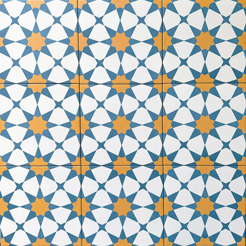 Agadir Sun and Sky Moroccan-style 20x20cm porcelain floor tiles laid in a repeating geometric star pattern in blue, white and warm yellow, shown as a grouped tile layout on a neutral background.