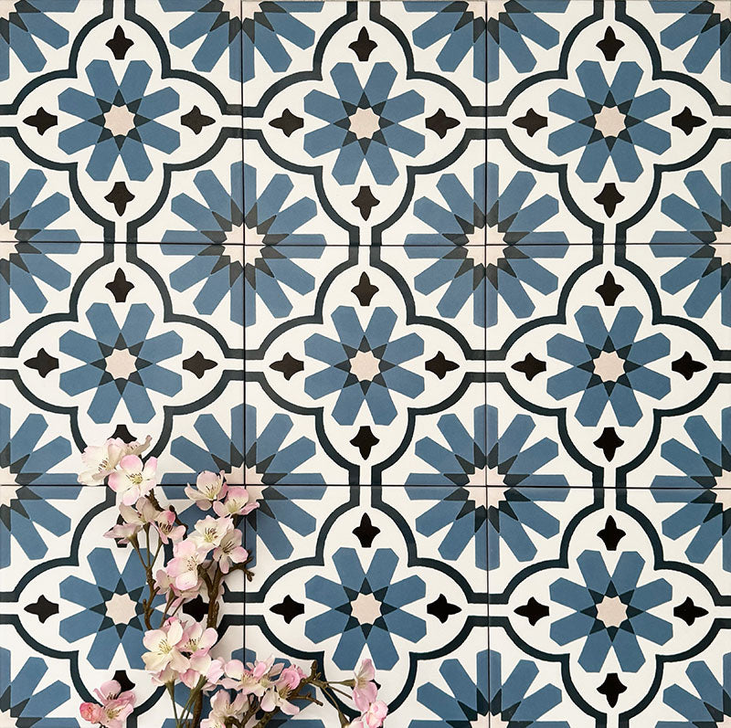Clara Azul Victorian Moroccan-style porcelain tiles in a 20 × 20cm format, laid in a repeating pattern to showcase the blue and white geometric design across the surface.