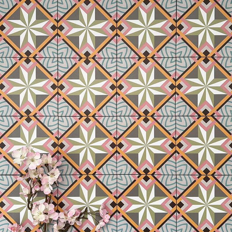 Cuba Star Mini Moroccan-style porcelain tiles in a 15×15cm square format, arranged in a repeating geometric star pattern with soft green, blue, pink and mustard tones, highlighting the tile’s crisp symmetry, fine detailing and decorative encaustic-style design.
