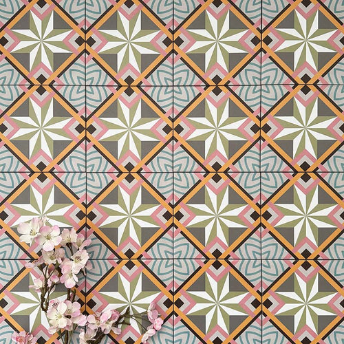 Cuba Star Mini Moroccan-style porcelain tiles in a 15×15cm square format, arranged in a repeating geometric star pattern with soft green, blue, pink and mustard tones, highlighting the tile’s crisp symmetry, fine detailing and decorative encaustic-style design.