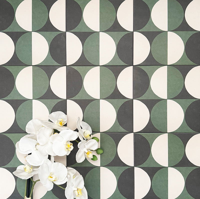 Abstract Circles Patterned Tiles in a 20x20cm format, shown in a repeating grid layout to highlight the bold circular design. Deep green, charcoal and soft cream tones create a striking yet balanced pattern, styled with floral accents to showcase the tiles as a decorative feature suitable for floors, walls or splashbacks.