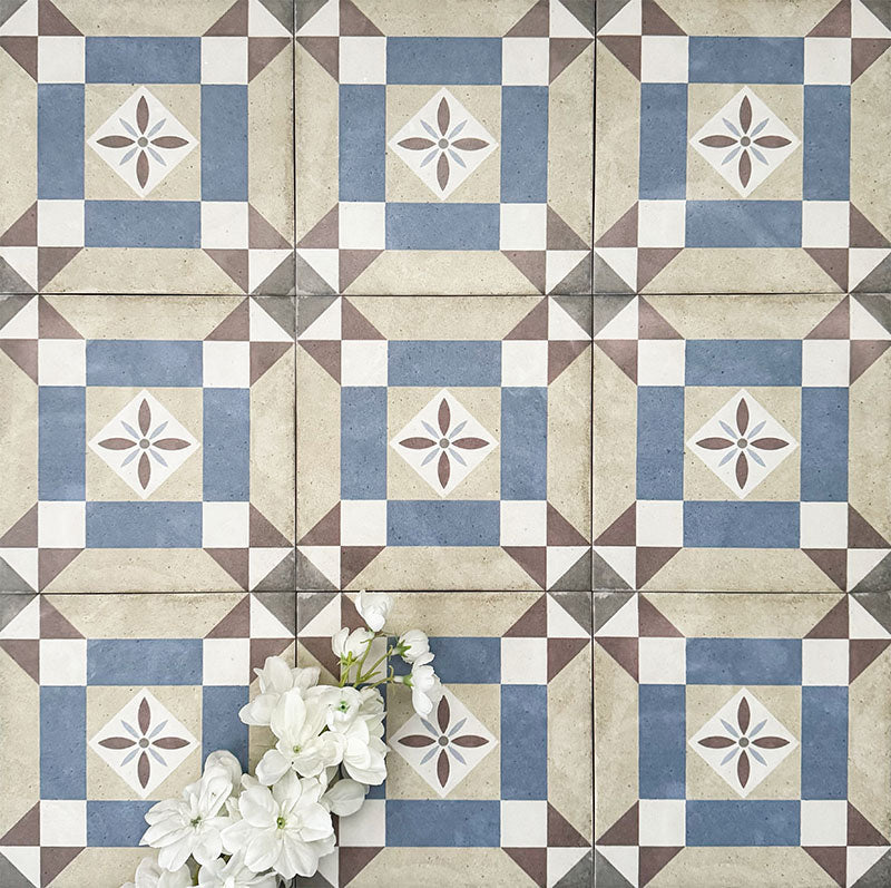 Viscount Harley Street 20×20cm Victorian-style porcelain wall and floor tiles laid in a repeating geometric square pattern with a central floral motif in soft blue, beige, warm grey and white tones, shown as a full tile layout with subtle tonal variation and floral styling.