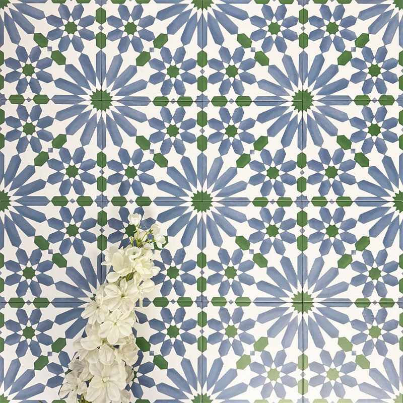 Fez Ocean Blue 20x20cm Moroccan-style porcelain wall tiles arranged in a repeating geometric pattern, featuring blue, white and green star motifs, styled with white floral accents for a fresh, decorative finish.