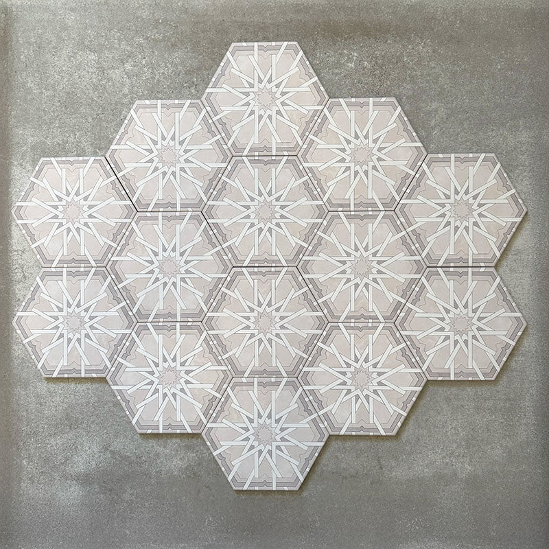 Grouped layout of Medina Hormuz Snow White Moroccan-style hexagon porcelain tiles, 18.7 × 21.6 cm, showcasing the full repeating star-inspired geometric pattern in white and soft grey tones on a neutral background.