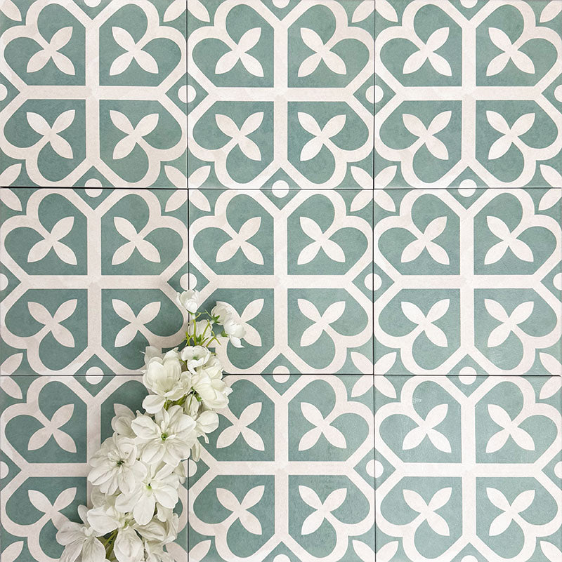 Ivy Green Victorian Moroccan style 20x20cm patterned tiles, shown in a flat lay with decorative plants highlighting the geometric design.