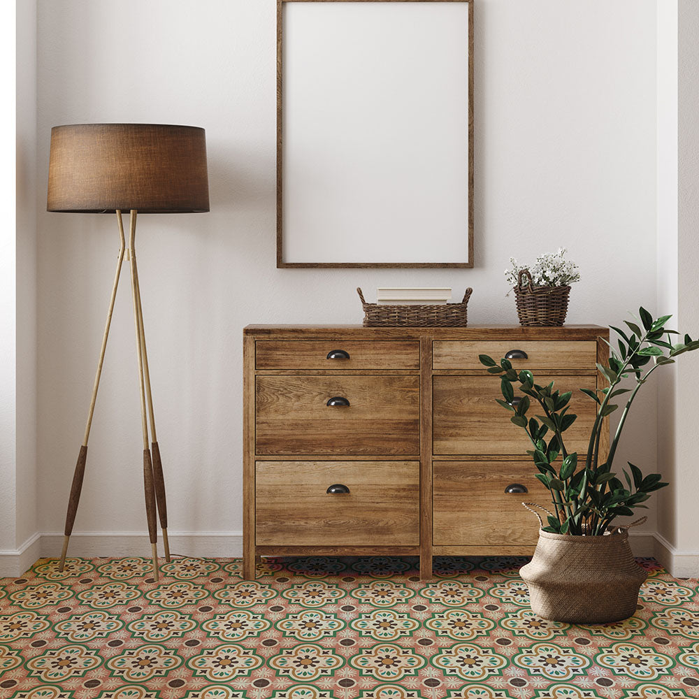 Hallway interior featuring Cuba Paradise Moroccan-style porcelain floor tiles in a 20×20cm square format, laid in a repeating floral pattern with coral, green, white and brown tones, paired with warm wooden furniture and neutral walls for a welcoming, character-filled finish.