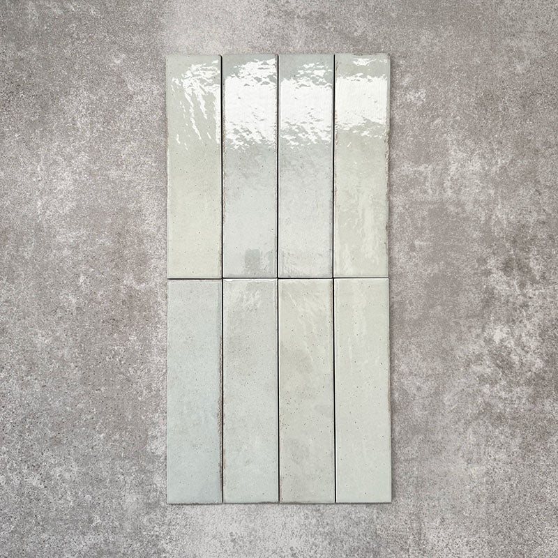 Nomad Mint Green brick wall tiles in a 6 × 24.6cm format, shown laid together to highlight the soft green colour, gloss finish and subtle surface variation.