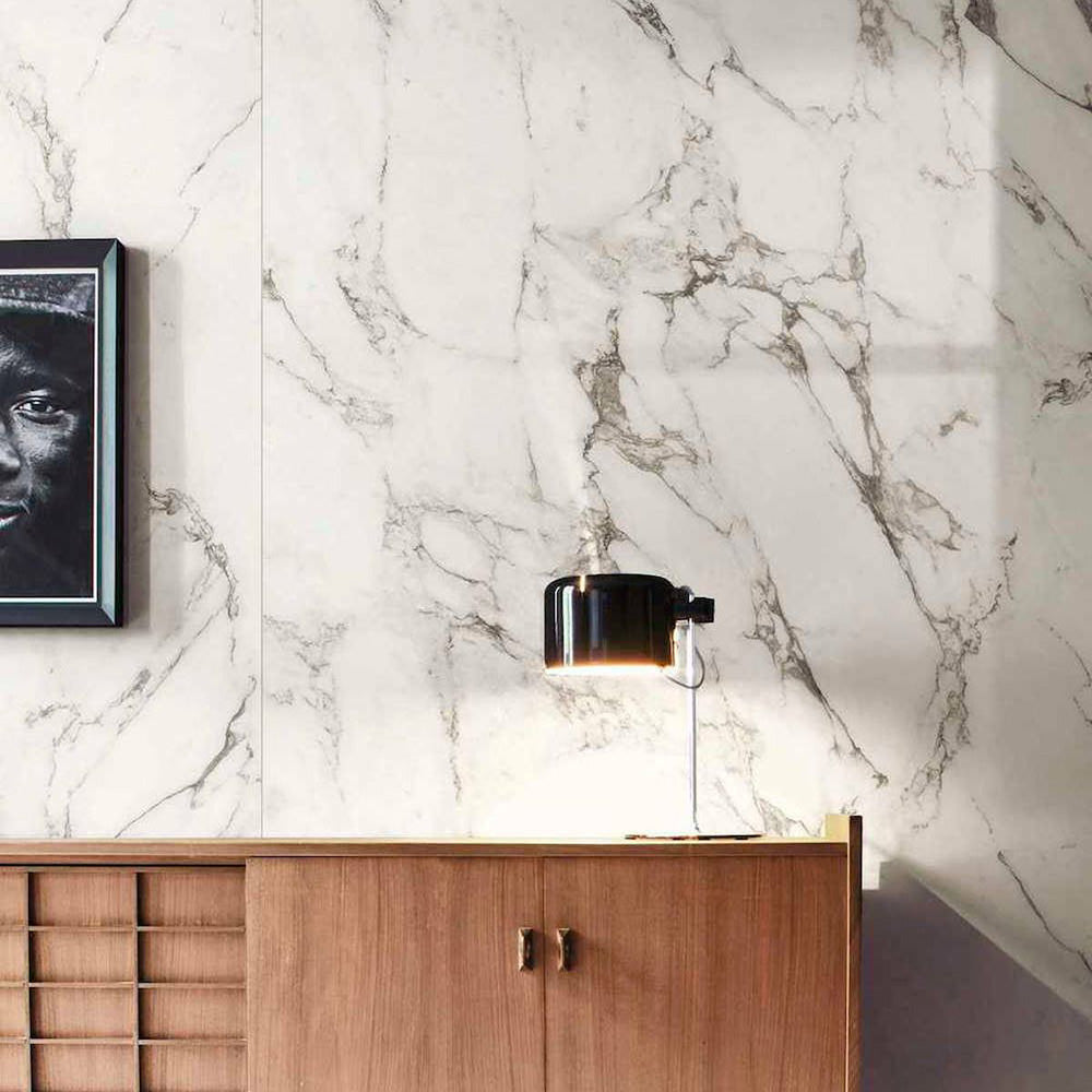 Interior detail featuring Hudson Calacatta Matt Marble 30 × 60cm porcelain wall tiles, showcasing a crisp white base with fine grey veining, paired with warm wood cabinetry and soft lighting to create a balanced, contemporary contrast.