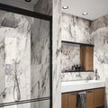 Bathroom interior featuring Hudson Capraia Matt Marble 60 × 120cm porcelain wall tiles, showcasing a crisp white base with bold, dramatic grey veining, paired with black-framed shower detailing and warm wood cabinetry for a striking, contemporary contrast.