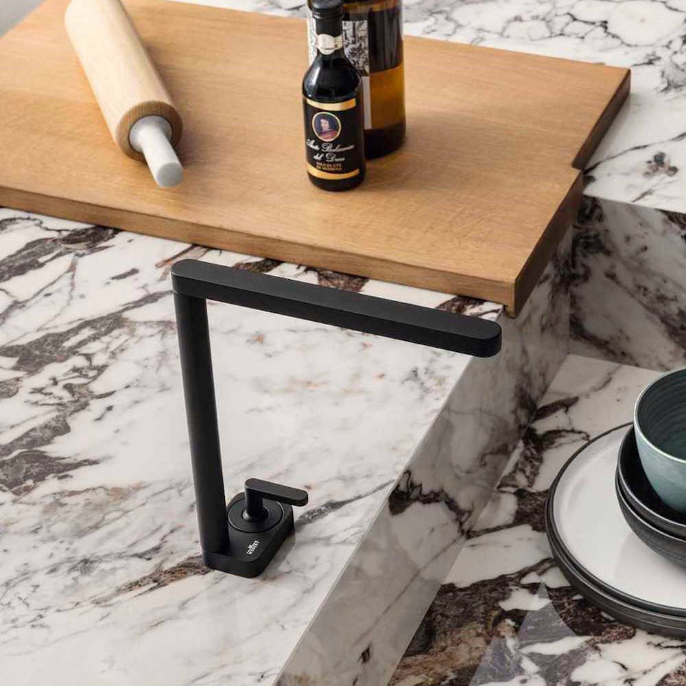Close-up of Hudson Capraia Matt Marble 60 × 60cm porcelain tiles, highlighting a crisp white base with bold, expressive dark veining, styled with warm wood and matte black fixtures to emphasise contrast and a refined marble effect.