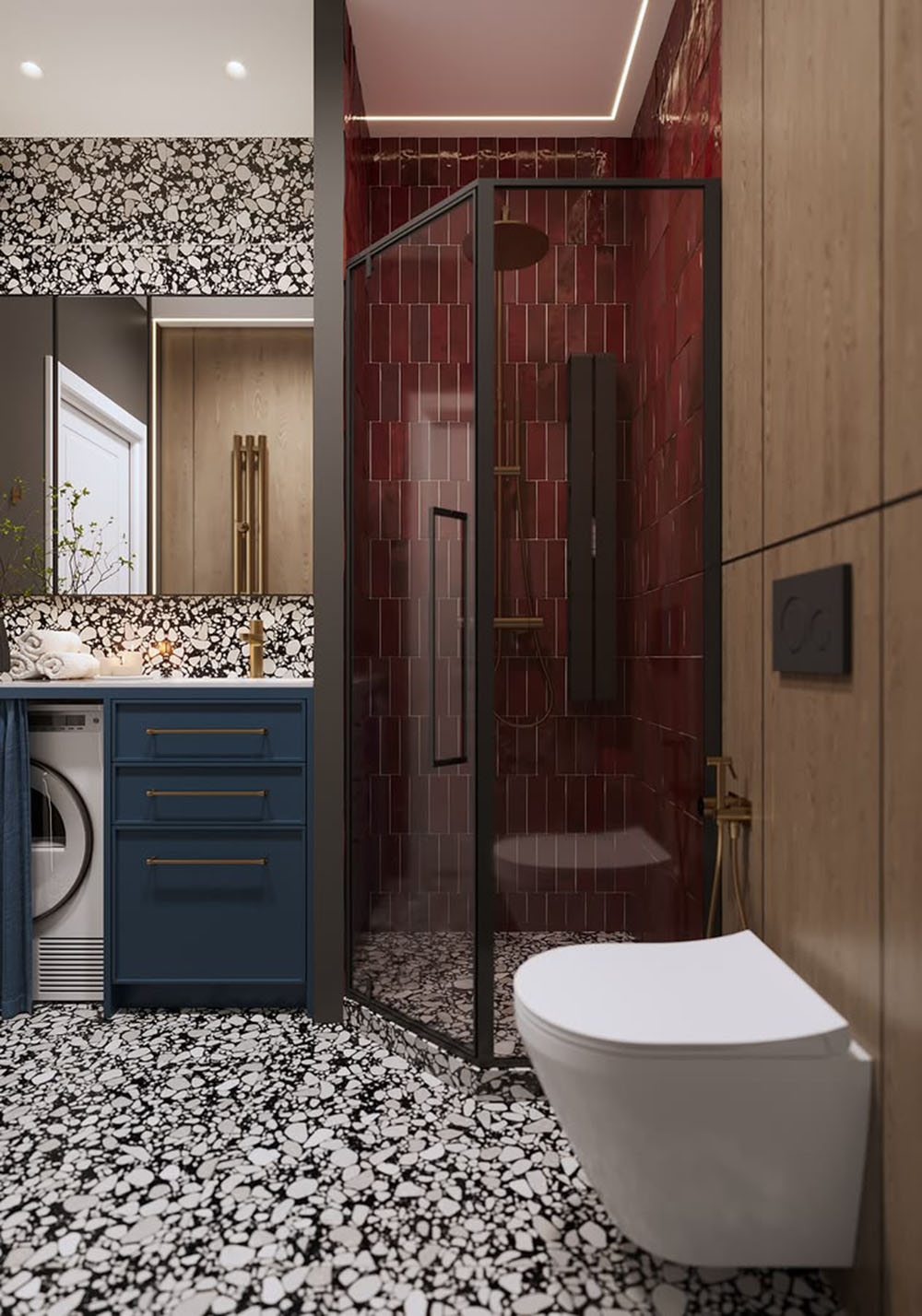 Bathroom setting featuring Shards Terrazzo Nero 59x118cm matt porcelain wall and floor tiles, showcasing a bold black base with contrasting white aggregate, paired with deep red brick tiles, blue cabinetry and brass fittings for a striking, contemporary finish.