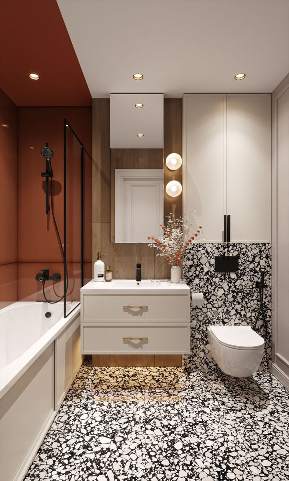 Bathroom setting featuring Shards Terrazzo Nero 59x118cm matt porcelain wall and floor tiles, showcasing a bold black base with contrasting white aggregate, paired with warm wood finishes, soft lighting and deep terracotta shower walls.