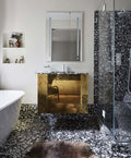 Bathroom setting featuring Shards Terrazzo Nero 59x59cm matt porcelain wall and floor tiles, showcasing a bold terrazzo effect with large white stone fragments set against a deep black base, used across the floor and shower enclosure to create a seamless, immersive finish, paired with a statement vanity, soft neutral walls and warm metallic accents for a refined, design-led look.