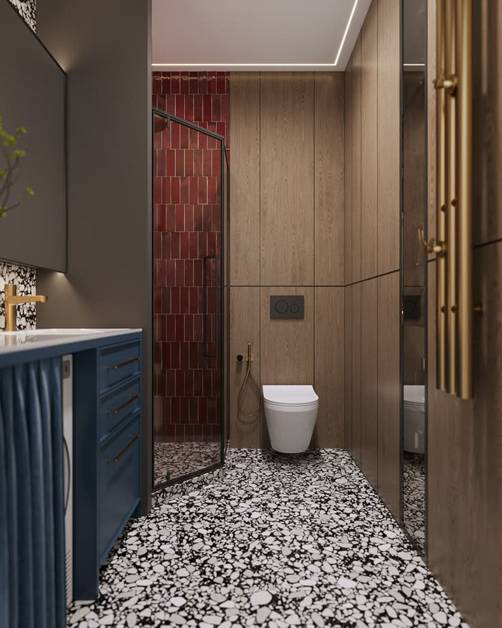 Bathroom setting featuring Shards Terrazzo Nero 59x118cm matt porcelain wall and floor tiles, showcasing a bold black base with contrasting white aggregate, paired with deep red brick tiles, blue cabinetry and brass fittings for a striking, contemporary finish.