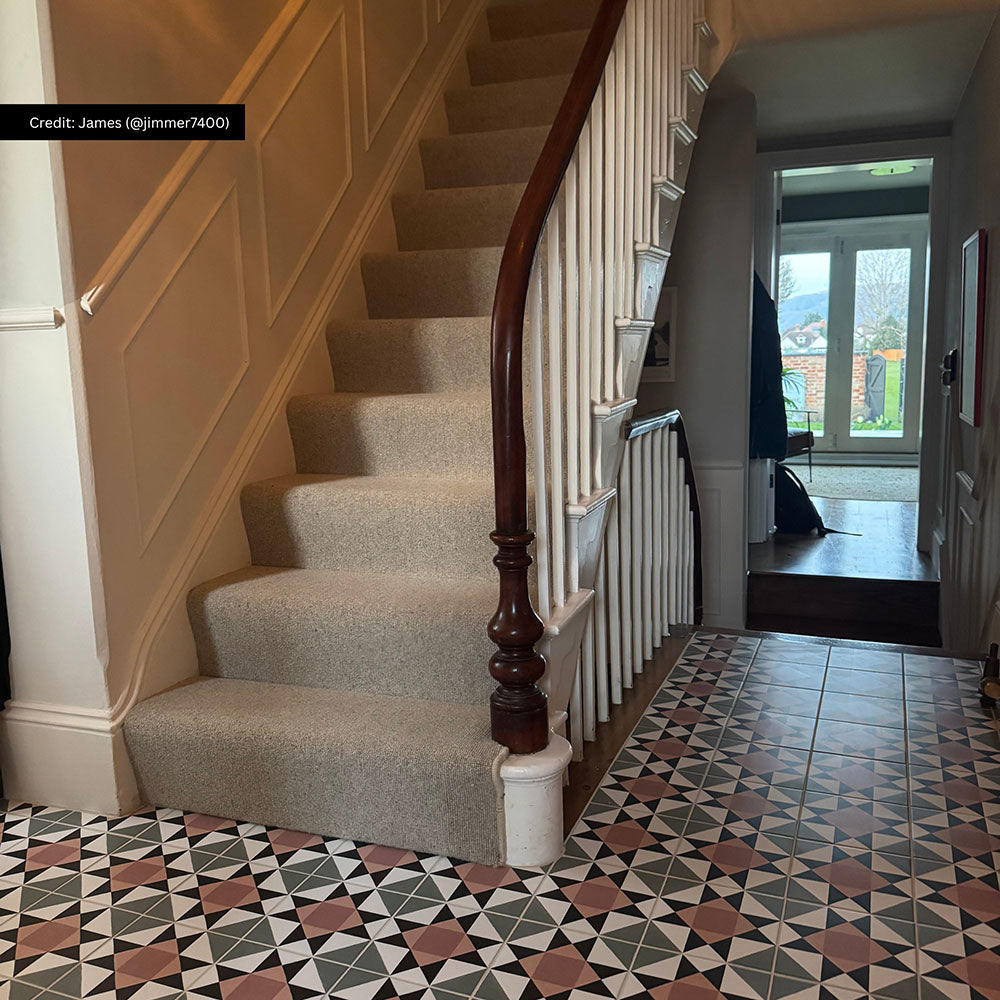 Hallway interior featuring Farnham Manor 20x20cm Victorian style floor tiles in soft green, blush and black tones, creating a timeless geometric entrance paired with classic panelling and a neutral stair runner.