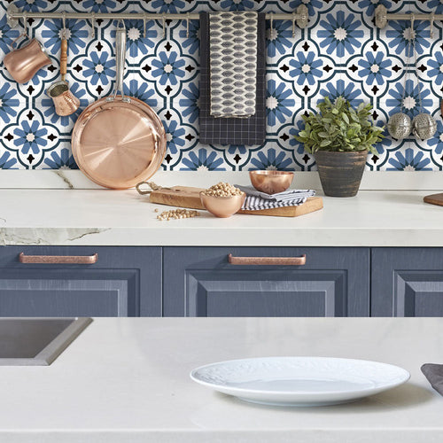 Kitchen featuring Clara Azul Victorian Moroccan-style porcelain tiles in a 20 × 20cm format, used as a patterned splashback behind worktops and open shelving for a bold, decorative look.