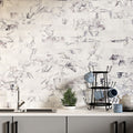 Kitchen splashback featuring Fayrouz Lilac 5x20cm natural marble tiles with a honed finish, installed in a horizontal brick layout, showcasing a soft white base with delicate lilac and grey veining, styled with neutral cabinetry, black accents, and everyday kitchen accessories for a clean, contemporary look.