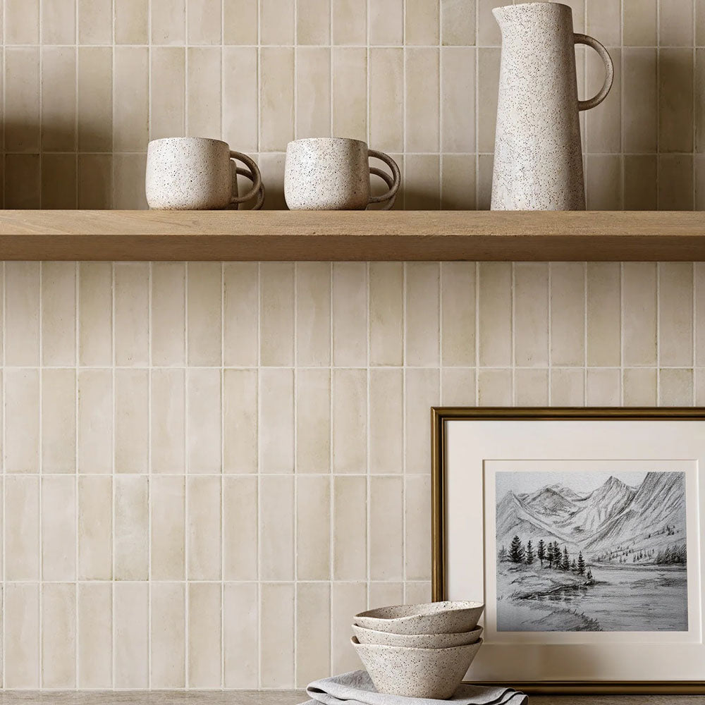 Kitchen featuring Benomar Canvas Moroccan Mini Brick 5x15cm matt wall tiles, installed in a vertical layout, showcasing soft neutral tones with a subtle handcrafted effect, paired with dark cabinetry and a warm, contemporary interior.