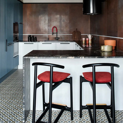 Kitchen setting featuring Viscount Park Road 20x20cm Victorian style wall and floor tiles, showcasing a repeating geometric pattern in soft grey and white tones, paired with rich brown wall tiles, dark worktops and contemporary cabinetry for a bold, design-led finish.