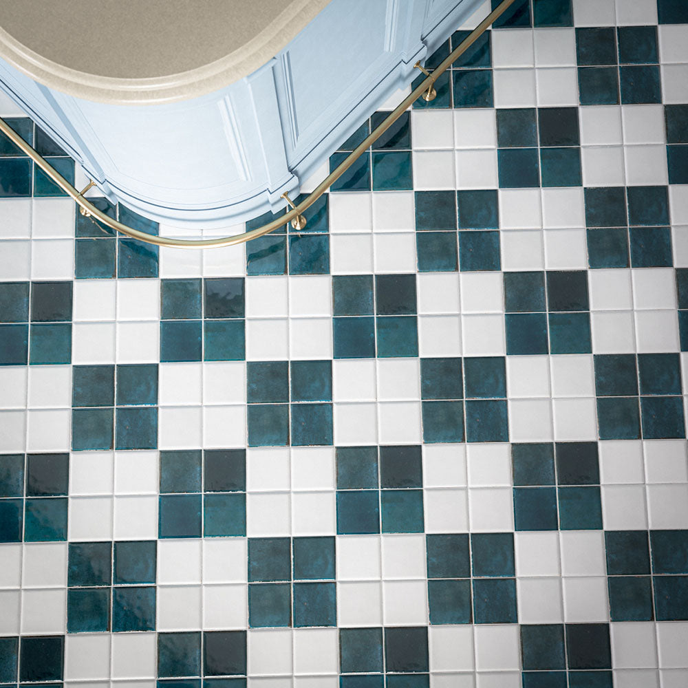 Kitchen featuring Levent Blue Square 10cm x 10cm gloss porcelain wall and floor tiles in a striking chequerboard design, combining deep blue and crisp white squares with subtle handmade-effect shade variation, paired with a brass handrail and elegant period architectural details.