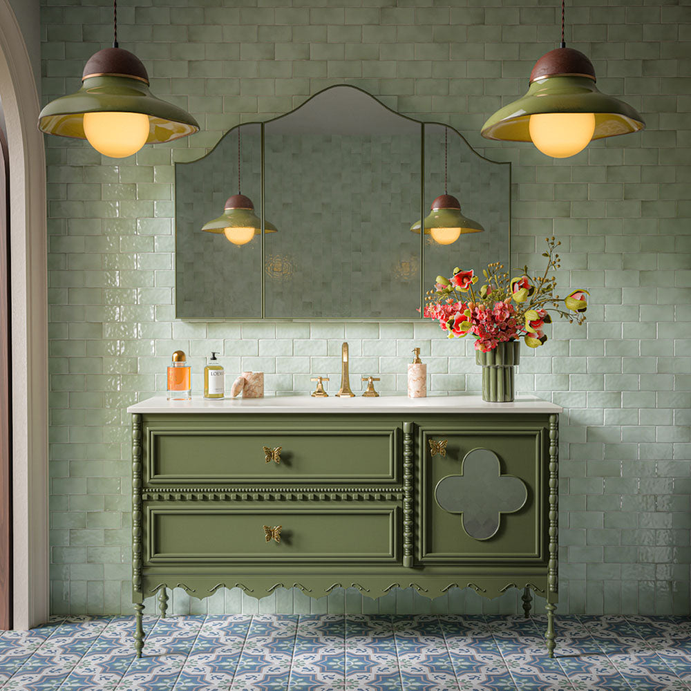 Traditional bathroom featuring Liberty Mint Green Rustic Effect Gloss wall tiles in a 7.5cm x 15cm format, paired with a sage green vanity unit, brass fittings, patterned floor tiles and decorative lighting.