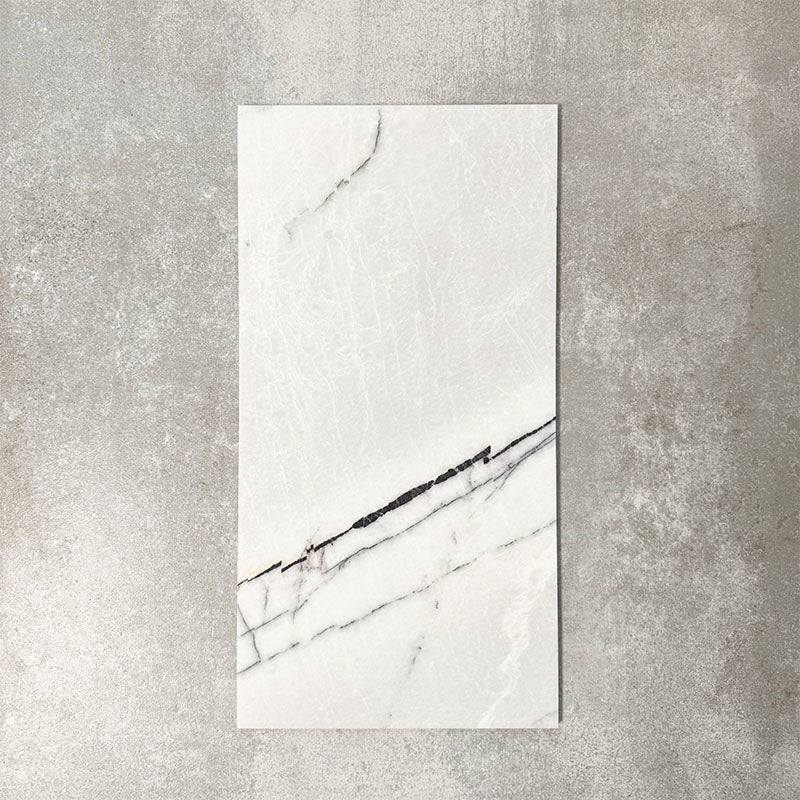 Fayrouz Lilac 30.5x61cm natural marble tiles with a honed finish, featuring a soft white base with subtle lilac undertones and fine grey veining, shown as a single tile sample against a neutral textured backdrop.