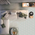 Living room featuring Medina Hormuz Sage Green/Grey Moroccan-style hexagon porcelain floor tiles, 18.7 × 21.6 cm, laid in a striking geometric pattern and styled with modern seating and soft neutral furnishings.