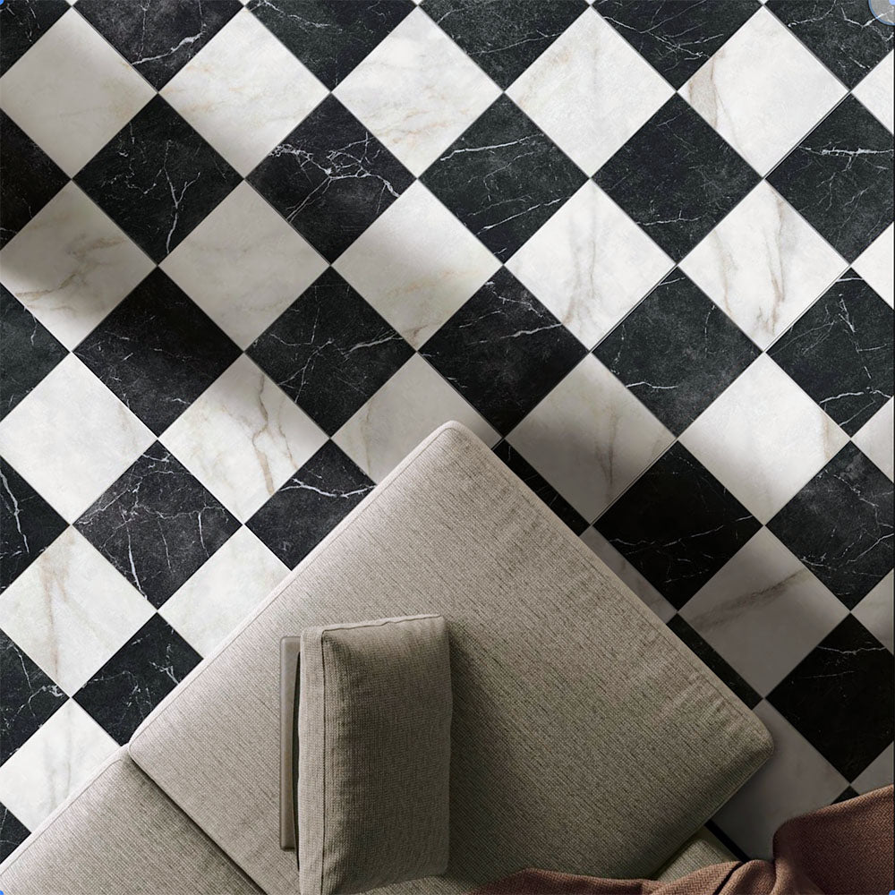 Living room floor featuring Vitoria Classic Bianco white marble-style porcelain chequerboard tiles in a 30 × 30cm format, combining white and black marble-effect squares laid diagonally to create a striking, timeless pattern, styled with soft neutral furniture for an elegant, contemporary interior.