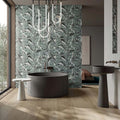Luxury bathroom featuring Lucca Bali 3D Décor 60 × 120cm porcelain wall tiles, showcasing layered tropical leaf patterns in soft green tones, paired with contemporary black sanitaryware and warm wood finishes.