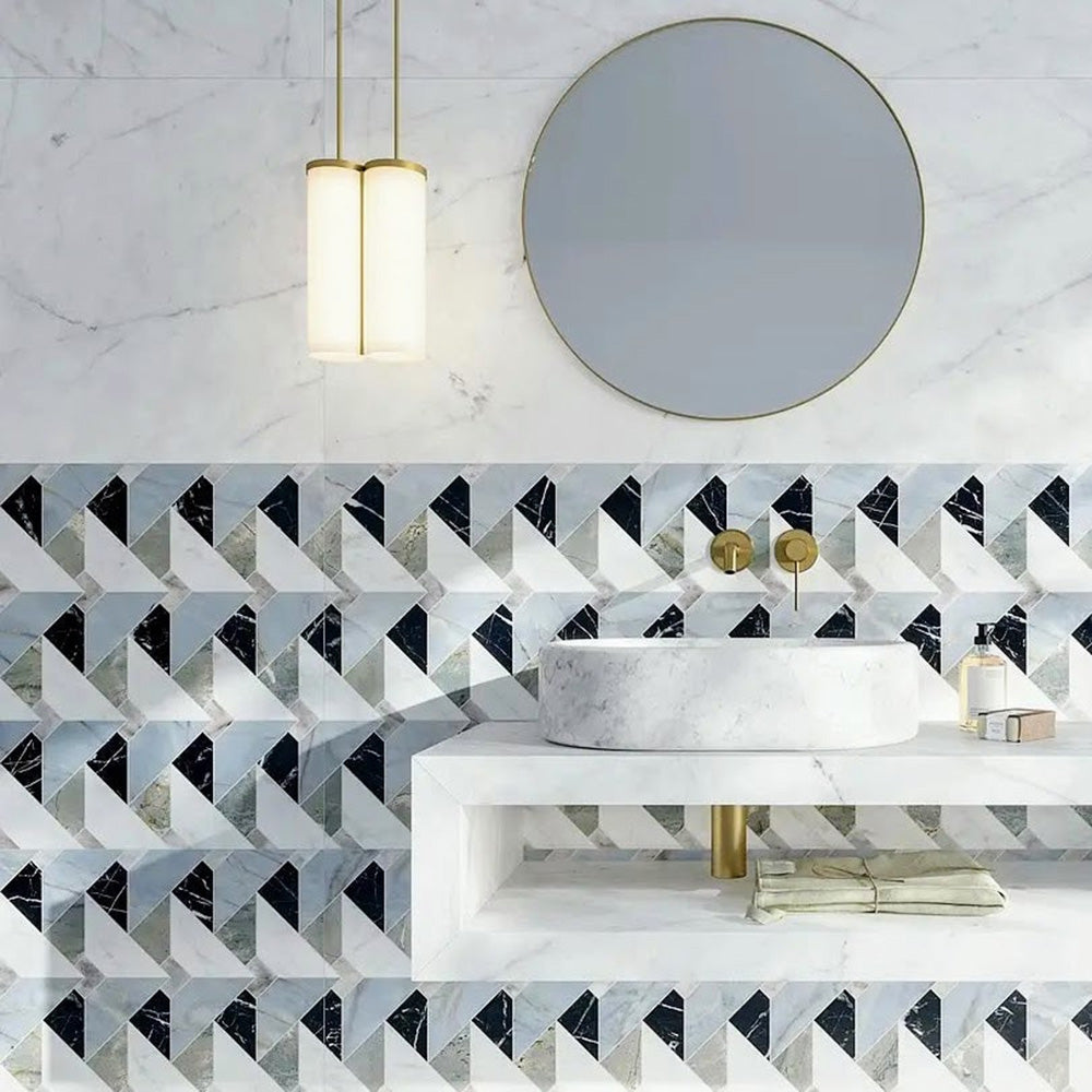 Bathroom interior featuring Lucca Diamond Tips 3D Décor 60 × 120cm porcelain wall and floor tiles, styled as a geometric feature wall with marble-effect surfaces, brass fittings, a floating vanity unit, and a round statement mirror for a refined contemporary finish.