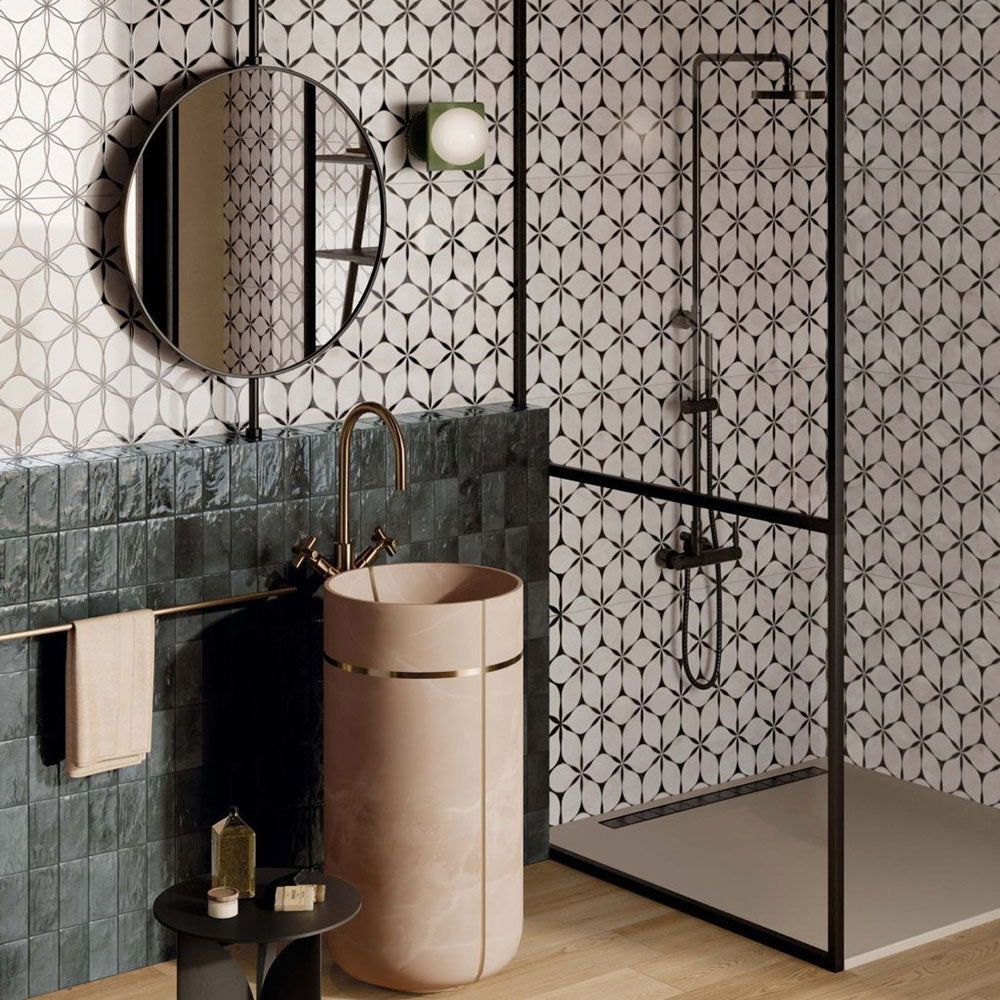 Bathroom interior featuring Lucca Flowers 3D Décor 60 × 120cm porcelain wall and floor tiles, showcasing a repeating floral geometric pattern in soft neutral tones, paired with glossy deep green wall tiles, black shower framing, and warm brass fittings for a contemporary statement finish.