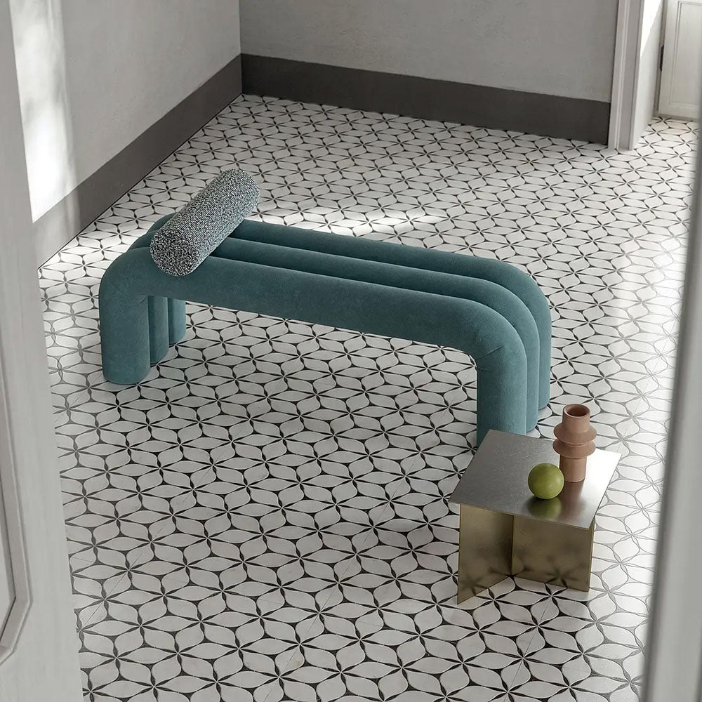 Interior space featuring Lucca Flowers 3D Décor 60 × 120cm porcelain wall and floor tiles, laid across the floor in a repeating floral geometric pattern with soft neutral tones, styled with sculptural furniture and contemporary metallic accents.