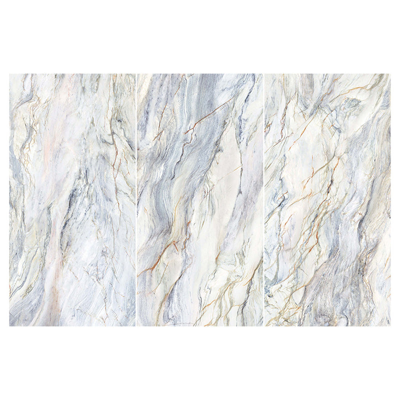 Flat lay of Lucca Quartz Lux 3D 60 × 120cm porcelain wall and floor tiles, featuring flowing marble-effect veining in soft cream, grey, and blue tones with a luxurious polished stone-inspired finish.