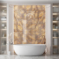 Luxury bathroom interior featuring Lumen Precious Stone Amber 60 × 120cm polished porcelain wall tiles, showcasing rich amber, honey, and smoky stone-inspired tones with dramatic crystalline movement, layered mineral detailing, and a reflective high-gloss finish, paired with a freestanding bath, brushed bronze fittings, fluted wall panelling, and soft ambient lighting.