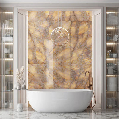 Luxury bathroom interior featuring Lumen Precious Stone Amber 60 × 120cm polished porcelain wall tiles, showcasing rich amber, honey, and smoky stone-inspired tones with dramatic crystalline movement, layered mineral detailing, and a reflective high-gloss finish, paired with a freestanding bath, brushed bronze fittings, fluted wall panelling, and soft ambient lighting.
